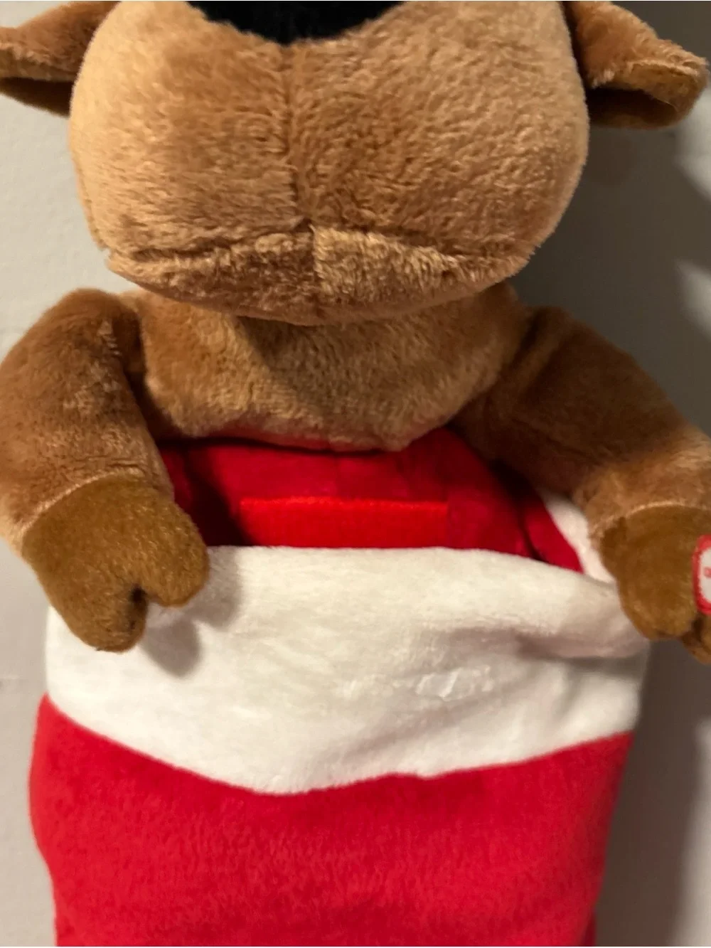 Holiday singing stocking with puppy dog sings jingle bells